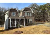 Brick two-story house with front yard and driveway at 565 Abbott Se Ct, Atlanta, GA 30354