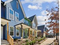 View of colorful new construction townhomes showcasing welcoming front porches at 1095 Tucker Ave # 106, Atlanta, GA 30310