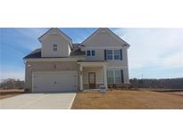 Charming two-story home with a two-car garage and inviting front porch at 6014 Spring Way, Stonecrest, GA 30038
