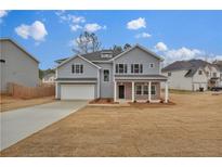 Charming two-story home with a brick-accented porch and attached garage at 250 Stonecreek Pkwy, Covington, GA 30016