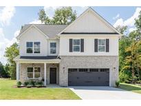 Charming two-story home with gray brick accents and a covered front porch at 3378 Pepperpike Ct, Loganville, GA 30052