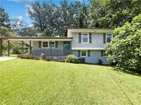 Charming split-level home with covered carport, fresh lawn and mature trees in a quiet neighborhood at 2492 Brentwood Ct, Decatur, GA 30032