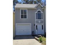 Charming home featuring a clean white garage door, elegant white trim, and stucco facade at 1041 Kennesborough Nw Rd, Kennesaw, GA 30144