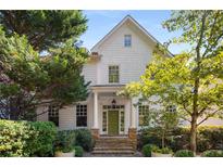 Charming two-story home with stone steps leading to the green front door with white trim and columns at 2493 Oldfield Nw Rd, Atlanta, GA 30327