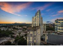 Stunning aerial view of a modern building against a colorful sunset sky at 3324 Peachtree Ne Rd # 2718, Atlanta, GA 30326