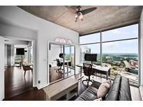 Modern living room with floor-to-ceiling windows offers city views and workspace at 3324 Peachtree Ne Rd # 2718, Atlanta, GA 30326
