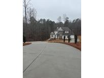 Two story house with stone accents and a large driveway at 3730 Reserve Overlook (Lot 8) Way, Cumming, GA 30041