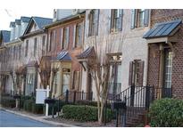 Row of charming townhouses with brick exteriors and landscaped yards at 10785 Arlington Pt, Alpharetta, GA 30022