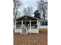 Charming single-story home featuring a quaint front porch with classic architectural details at 115 Montgomery St, Atlanta, GA 30317