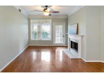Bright living room with hardwood floors, fireplace, and large window at 955 Juniper Ne St # 2324, Atlanta, GA 30309