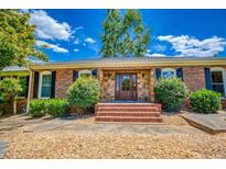 Inviting front entrance with stone accents, brick steps, and a beautiful wood door at 3700 Tom Brewer Rd, Loganville, GA 30052