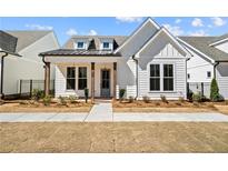 Charming new construction home featuring a manicured lawn and craftsman-style details at 505 Godfrey Dr, Cumming, GA 30040