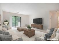 Bright living room with sliding glass door to balcony, comfortable seating, and large TV at 300 Johnson Ferry Ne Rd # A203, Sandy Springs, GA 30328