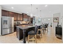Modern kitchen features a large island with seating and stainless steel appliances at 5410 Whisper Ct, Cumming, GA 30028