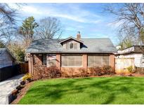 Charming brick home with a well-manicured lawn and inviting curb appeal in a quiet neighborhood at 1789 Thompson Ave, Atlanta, GA 30344