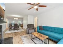 Bright living room with teal sofa, recliner, and wood coffee table at 750 Dalrymple Rd # C1, Atlanta, GA 30328