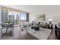 Spacious living room with hardwood floors, city view, and modern furniture at 1080 Peachtree Ne St # 1309, Atlanta, GA 30309