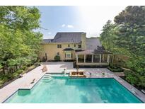 A backyard swimming pool and patio highlight this home's outdoor amenities at 1357 Baniff Ct, Snellville, GA 30078