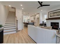 Open living room features a cozy fireplace and flows into the kitchen at 1996 Deco Dr, Kennesaw, GA 30144