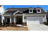 Newly constructed home with gray siding, white trim, and a two-car garage at 3577 Fishpond Cir, Dacula, GA 30019