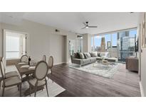 Bright living area with a dining space, hard wood floors, and amazing views of the surrounding skyscrapers at 3325 Piedmont Ne Rd # 1801, Atlanta, GA 30305