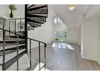 Bright living room featuring hardwood floors, spiral staircase, and large windows at 882 Cedar Canyon Se Sq, Marietta, GA 30067