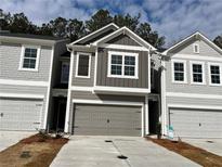 Charming new construction townhomes showcasing craftsman-style architecture and attached garages at 5146 Longview Run, Decatur, GA 30035