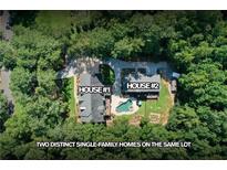 Aerial view of two single-Gathering homes on the same lot, surrounded by lush greenery and mature trees at 2010 Stonehedge Rd, Roswell, GA 30075