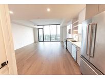 Open concept living room with hardwood floors and city views at 788 W Marietta Nw St # 1707, Atlanta, GA 30318