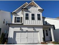 Charming two-story home with a white exterior, symmetrical window placements, and attached two-car garage at 631 Skytop Dr, Cumming, GA 30040