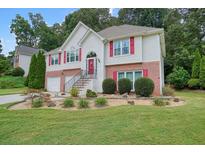 Charming two-story home with brick accents, well-manicured landscaping, and inviting curb appeal at 1215 Wandering Vine Ct, Mableton, GA 30126