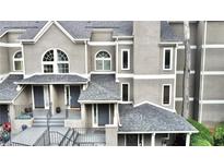 Charming townhome with a modern gray exterior, inviting entrance, and well-maintained landscaping at 14 Saint Claire Ne Ln, Atlanta, GA 30324