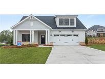 Charming single-Gathering home featuring a welcoming front porch and a two-car garage at 5365 Maggie Mae Ln, Cumming, GA 30028