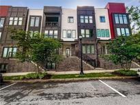 Modern townhome exterior with brick accents, multiple stories, and a well-maintained lawn at 371 Pratt Se Dr # 203, Atlanta, GA 30315