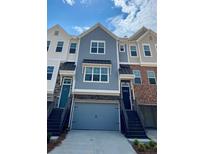 Charming townhome exterior featuring varied textures, private entrances, and attached garages at 2539 Hedgeway Cir, Kennesaw, GA 30144