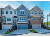 Charming townhomes with varied colors, attached garages, and welcoming front entrances at 2539 Hedgeway Cir, Kennesaw, GA 30144