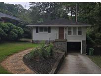 Charming single-story home with a stone accent wall and driveway parking at 2121 Arlington Ne Ave, Atlanta, GA 30324