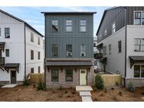 Charming new construction home with a brick foundation and a stylish yellow front door at 3318 Stillwood Ln, Atlanta, GA 30354