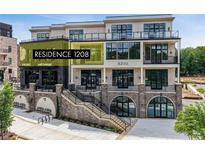Attractive three-story condo building with outdoor terraces and street-level storefronts at 8200 Main S St # 1208, Woodstock, GA 30188