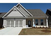 Charming single-story home featuring a clean design, attached garage, and well-manicured lawn, perfect for modern living at 625 Moorhen Way, Loganville, GA 30052