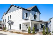 Charming two-story home featuring white siding, gray accents, and a welcoming front porch at 3324 Springhaven Ave, Atlanta, GA 30354