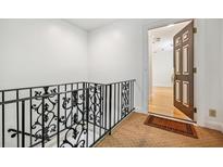 Hallway with ornate railings and an open doorway, revealing hardwood floors at 1261 Lavista Rd # F-3, Atlanta, GA 30324