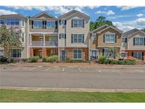 Townhome complex with well-maintained exteriors, landscaping, and convenient parking at 194 Riverstone Commons Cir, Canton, GA 30114