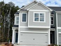Charming two-story home with a gray facade, a two-car garage, and a well-maintained lawn at 5174 Longview Run, Decatur, GA 30035