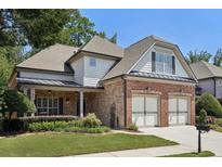 Charming two-story home with a beautifully landscaped yard and a two-car garage at 11213 Brookhavenclub Dr, Johns Creek, GA 30097
