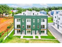 Modern townhome with green exterior, white accents, and individual balconies at 2029 Memorial Dr # 34, Atlanta, GA 30317