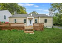 Charming single-story home with a wooden deck and well-maintained front yard at 1159 Fair Sw St, Atlanta, GA 30314