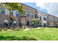 Modern townhouses with brick and gray siding, showcasing a manicured lawn at 2141 Burnside Nw Dr, Atlanta, GA 30318