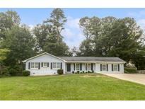 Charming single-story home with a well-manicured lawn and classic architectural details at 720 Smithstone Se Rd, Marietta, GA 30067