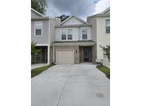 Charming townhome with neutral siding, brick accents, attached garage and newly paved driveway at 3405 Ripple Loop # 127, South Fulton, GA 30349